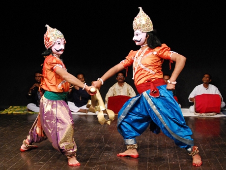 Two performers wearing traditional masks