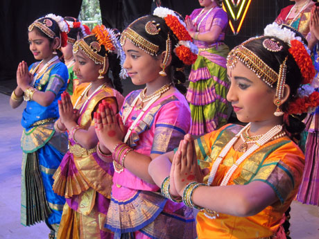 Four girls standing together with hands clasped during Diwali celebrations